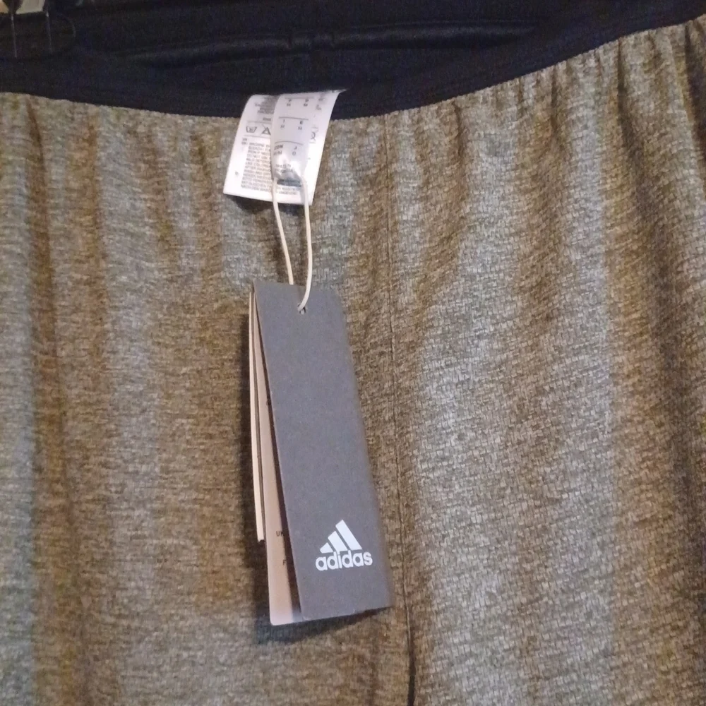 NWT   Adidas knit Grey shorts. Black waist band, white stripes. Size medium.
